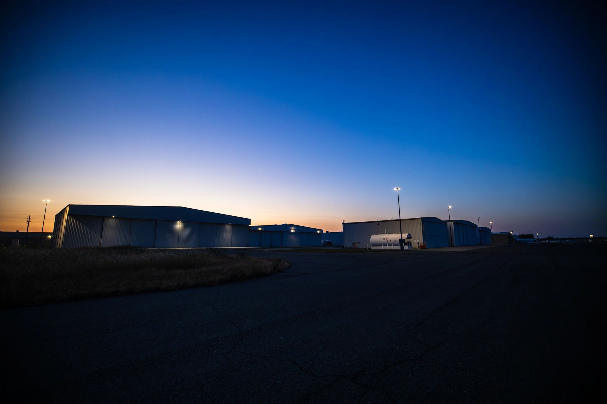 Wide shot of airplane hangar at dusk